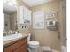 Bright bathroom with a single sink vanity, updated fixtures, and a window with shutters at 2998 Kramer Ct, The Villages, FL 32163