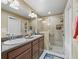 Well-lit bathroom with a double vanity, spacious shower, and neutral color palette at 2998 Kramer Ct, The Villages, FL 32163