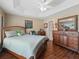 Comfortable bedroom with wooden furniture, including a large dresser and decorative mirror at 2998 Kramer Ct, The Villages, FL 32163