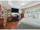 Bedroom featuring a desk, wooden dresser, and plantation shutters for natural light at 2998 Kramer Ct, The Villages, FL 32163
