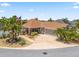 Well-manicured home boasts a spacious driveway, lush plantings, and a welcoming facade at 2998 Kramer Ct, The Villages, FL 32163