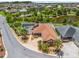 Charming home features a screened pool, meticulous landscaping, and a serene pond view at 2998 Kramer Ct, The Villages, FL 32163