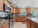 Bright kitchen featuring stainless steel appliances, granite countertops, and ample cabinet space at 2998 Kramer Ct, The Villages, FL 32163