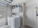 Functional laundry room with modern washer and dryer, storage cabinets, and ample space at 2998 Kramer Ct, The Villages, FL 32163