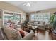 Comfortable living room with high ceilings, multiple sofas, and a view of the outdoor patio and pool area at 2998 Kramer Ct, The Villages, FL 32163