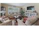 Living room boasts comfortable seating, plantation shutters, and elegant decor for a relaxing atmosphere at 2998 Kramer Ct, The Villages, FL 32163