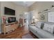 Relaxing living room with a comfortable sofa, mounted TV, and neutral decor at 2998 Kramer Ct, The Villages, FL 32163