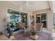 Cozy screened patio with glass tables and comfortable seating for relaxing and enjoying the outdoors at 2998 Kramer Ct, The Villages, FL 32163
