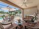 Relaxing screened patio features a ceiling fan, comfortable seating, and views of the inviting pool area at 2998 Kramer Ct, The Villages, FL 32163