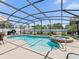 Sparkling screened pool and spa offer a refreshing retreat with plenty of space for relaxation and entertainment at 2998 Kramer Ct, The Villages, FL 32163