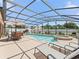 Enjoy the Florida sunshine in this beautiful screened-in pool and spa with ample seating and lounging space at 2998 Kramer Ct, The Villages, FL 32163