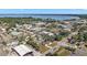 Scenic aerial view of a charming neighborhood with lake views, lush trees, and a mix of residential and commercial buildings at 30 E Key Ave, Eustis, FL 32726