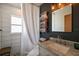 Stylish bathroom featuring a marbled vanity, custom towel rack, and updated tiling at 30 E Key Ave, Eustis, FL 32726