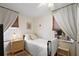 This bedroom features neutral walls, natural light, ceiling fan, and wood-look flooring at 30 E Key Ave, Eustis, FL 32726