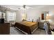 Inviting bedroom with a neutral color palette, ceiling fan and natural light from the window at 30 E Key Ave, Eustis, FL 32726