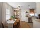 Dining area features an antique cabinet, round wood table, and a view into the updated kitchen at 30 E Key Ave, Eustis, FL 32726