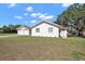 Ranch-style home featuring a manicured lawn and a detached two-car garage at 30 E Key Ave, Eustis, FL 32726
