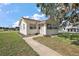 Charming single-story home with a well-maintained lawn and inviting walkway at 30 E Key Ave, Eustis, FL 32726