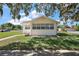 Charming single-story home featuring a well-maintained lawn and classic architectural design with bright white walls at 30 E Key Ave, Eustis, FL 32726