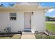 A close up of the home's front entrance and a 'Home Sweet Home' doormat at 30 E Key Ave, Eustis, FL 32726