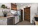 Updated kitchen features stainless steel appliances, open shelving, and a sliding wood plank door at 30 E Key Ave, Eustis, FL 32726