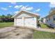 A close up exterior of a two-car detached garage with white doors at 30 E Key Ave, Eustis, FL 32726