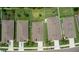 An aerial view showcases a row of well-maintained homes with neat landscaping, driveways, and neighborhood playgrounds at 3060 Neverland Dr, New Smyrna Beach, FL 32168
