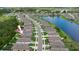Aerial view of a residential neighborhood highlights single-Gathering homes, street layout and nearby pond at 3060 Neverland Dr, New Smyrna Beach, FL 32168