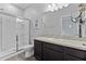 Bathroom featuring a vanity with solid surface countertop, toilet and glass-enclosed walk-in shower at 3060 Neverland Dr, New Smyrna Beach, FL 32168
