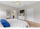 Cozy bedroom featuring a queen bed, neutral walls, and view into the ensuite bathroom at 3060 Neverland Dr, New Smyrna Beach, FL 32168