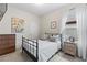 Bedroom featuring a full-sized bed, neutral walls, and bright window with sheer white curtains at 3060 Neverland Dr, New Smyrna Beach, FL 32168