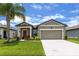 Charming single-story home with well-maintained lawn, colorful landscaping and neutral color palette at 3060 Neverland Dr, New Smyrna Beach, FL 32168