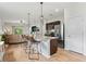 Modern kitchen island features bar stool seating, pendant lighting, and stainless steel appliances at 3060 Neverland Dr, New Smyrna Beach, FL 32168