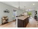 Bright kitchen island features pendant lighting, barstool seating, and an open view to the living area at 3060 Neverland Dr, New Smyrna Beach, FL 32168