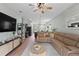 Open-concept living room featuring a large sectional sofa and seamless connection to the kitchen and dining area at 3060 Neverland Dr, New Smyrna Beach, FL 32168
