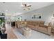 Bright, open-concept living room features a sectional sofa, pendant lighting and views of the modern kitchen at 3060 Neverland Dr, New Smyrna Beach, FL 32168