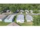 Overhead view of a neighborhood displaying tidy homes, landscaped yards, and mature trees in a serene setting at 32335 Oak Park Dr, Leesburg, FL 34748
