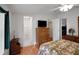 Bright bedroom with ceiling fan, closet, and en-suite bathroom access for added convenience at 32335 Oak Park Dr, Leesburg, FL 34748