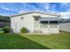 Exterior of a cozy home with a star decoration, featuring a well-kept lawn and ample natural light at 32335 Oak Park Dr, Leesburg, FL 34748