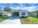 Charming single-story home with carport, decorative fish accents, and well-maintained landscaping at 32335 Oak Park Dr, Leesburg, FL 34748