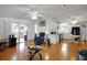 Open-concept living room and kitchen with bright lighting and access to the lanai through sliding doors at 32335 Oak Park Dr, Leesburg, FL 34748