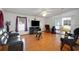 Spacious living room with hardwood floors, modern furniture, and sliding door access to the lanai at 32335 Oak Park Dr, Leesburg, FL 34748