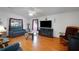 Spacious living room with hardwood floors, comfortable seating, and a fireplace, ideal for relaxation at 32335 Oak Park Dr, Leesburg, FL 34748