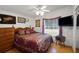 Inviting main bedroom with a cozy queen-size bed, natural light, and charming decor at 32335 Oak Park Dr, Leesburg, FL 34748