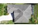 Aerial view of roof and driveway with blue skies and surrounding foliage at 3559 Chapel Hill Blvd, Clermont, FL 34711