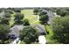 Wide aerial view of a neighborhood, featuring homes nestled amidst trees and green fairways at 3559 Chapel Hill Blvd, Clermont, FL 34711