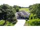 Overhead view of a home with a well-kept lawn, set against the backdrop of a lush golf course at 3559 Chapel Hill Blvd, Clermont, FL 34711
