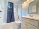 Bathroom featuring a bathtub with blue shower curtain, and a white vanity at 3559 Chapel Hill Blvd, Clermont, FL 34711