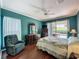 Well-lit bedroom featuring hardwood floors, ceiling fan, and sliding glass door to the outside at 3559 Chapel Hill Blvd, Clermont, FL 34711