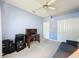 Bedroom featuring a desk, ceiling fan, and a blue couch at 3559 Chapel Hill Blvd, Clermont, FL 34711